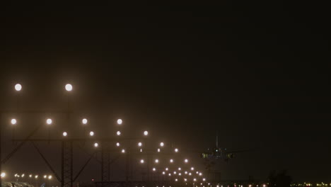 airplane landing at night in foggy conditions