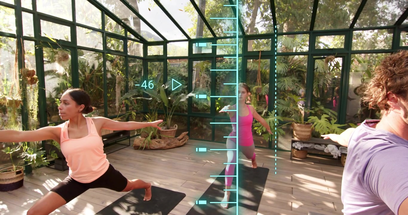 Group assuming Warrior II after count on mats, holding poses and viewing fitness metrics