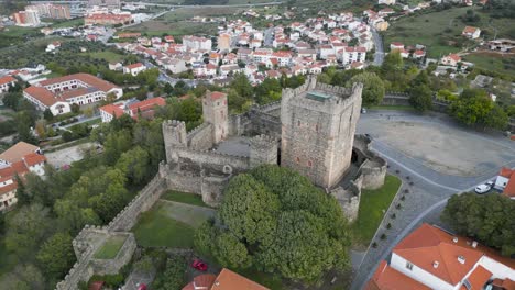 drone circles around tower of medieval castle in historic center of braganza portugal