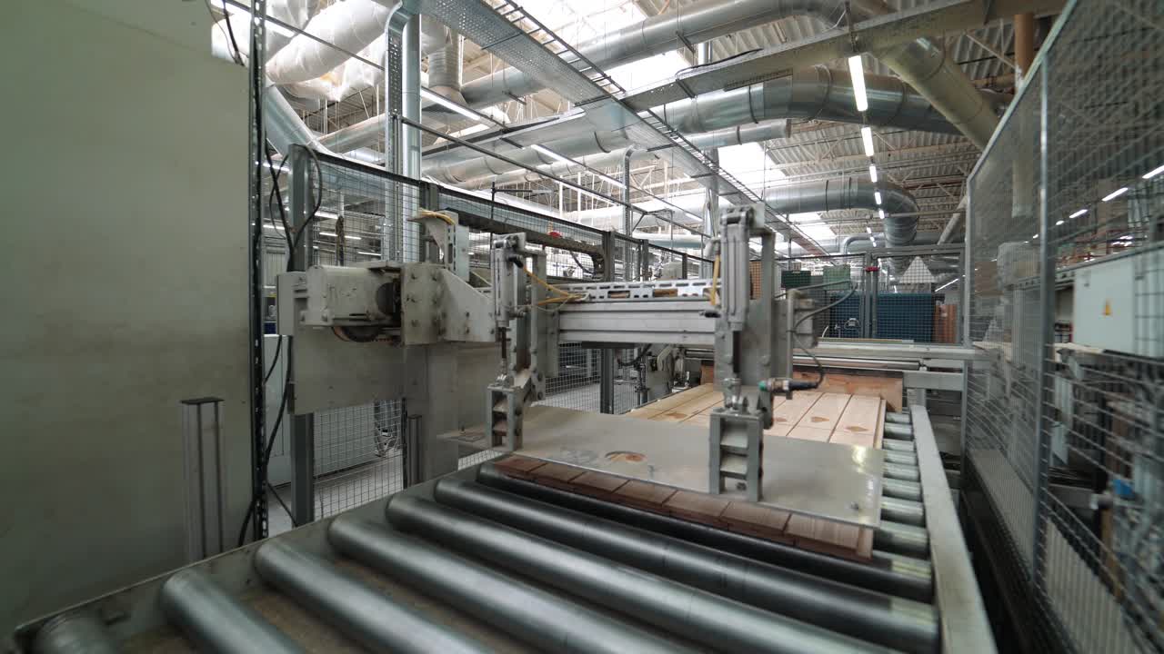 parquet board is polishing on a modern technological line at a wood processing plant