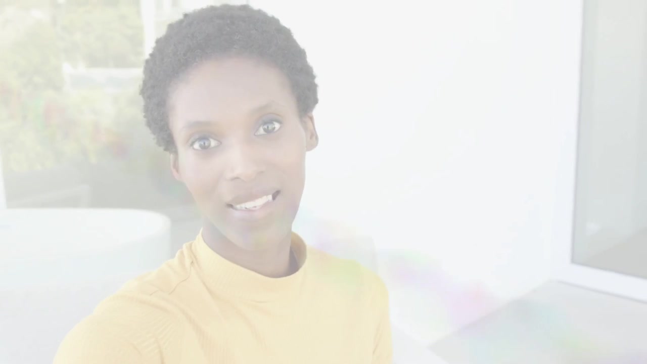 Vertical video: Holding selfie phone, host in yellow top speaking and pointing to camera on terrace
