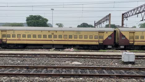 4K-shot-of-train-tracks-and-trains-at-a-station-in-kolkata,-west-bengal