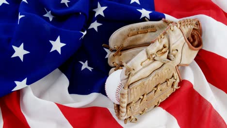 baseball and gloves on an american flag