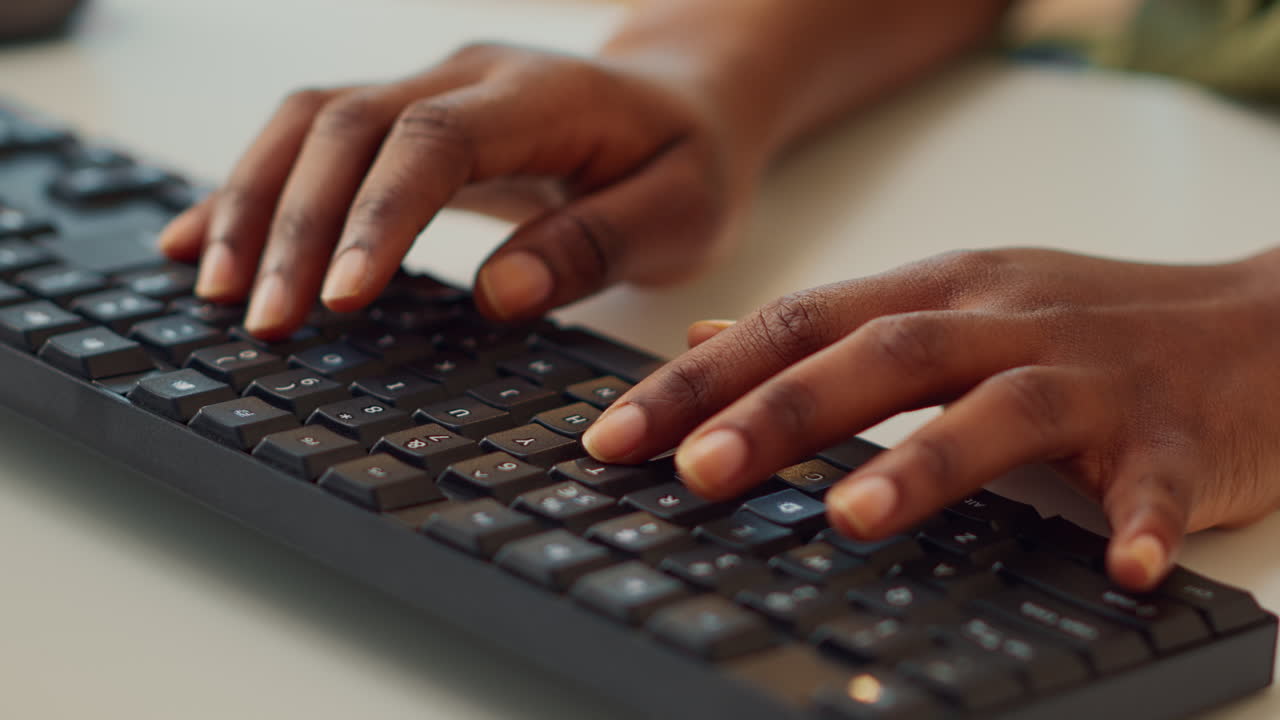 Young employee typing information on computer