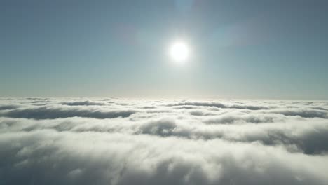 drone flying above clouds with the late afternoon sunlight