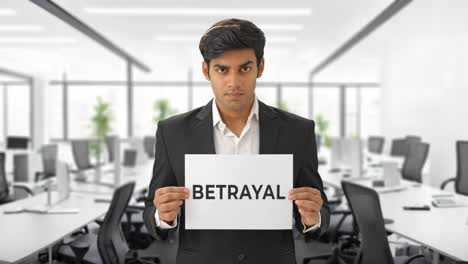 angry indian manager holding betrayal banner