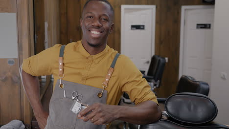 happy barber in a stylish barbershop