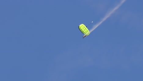 skydivers perform aerial maneuvers under parachutes