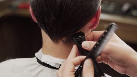 close-up of a hair trimmer haircut from behind on the back of the head