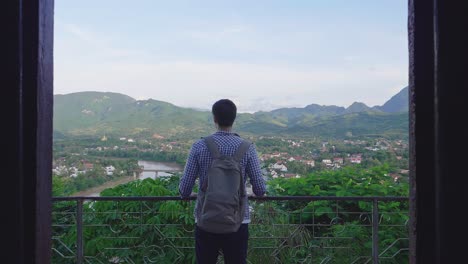 Man Looking at Scenic View from a Balcony