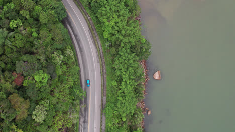 aerial birdseye flying over riverside road, brazil