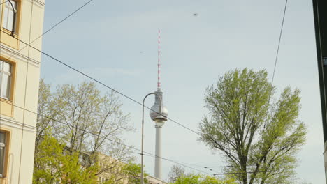 a vibrant daytime scene in berlin, with the iconic television tower set against a clear blue sky