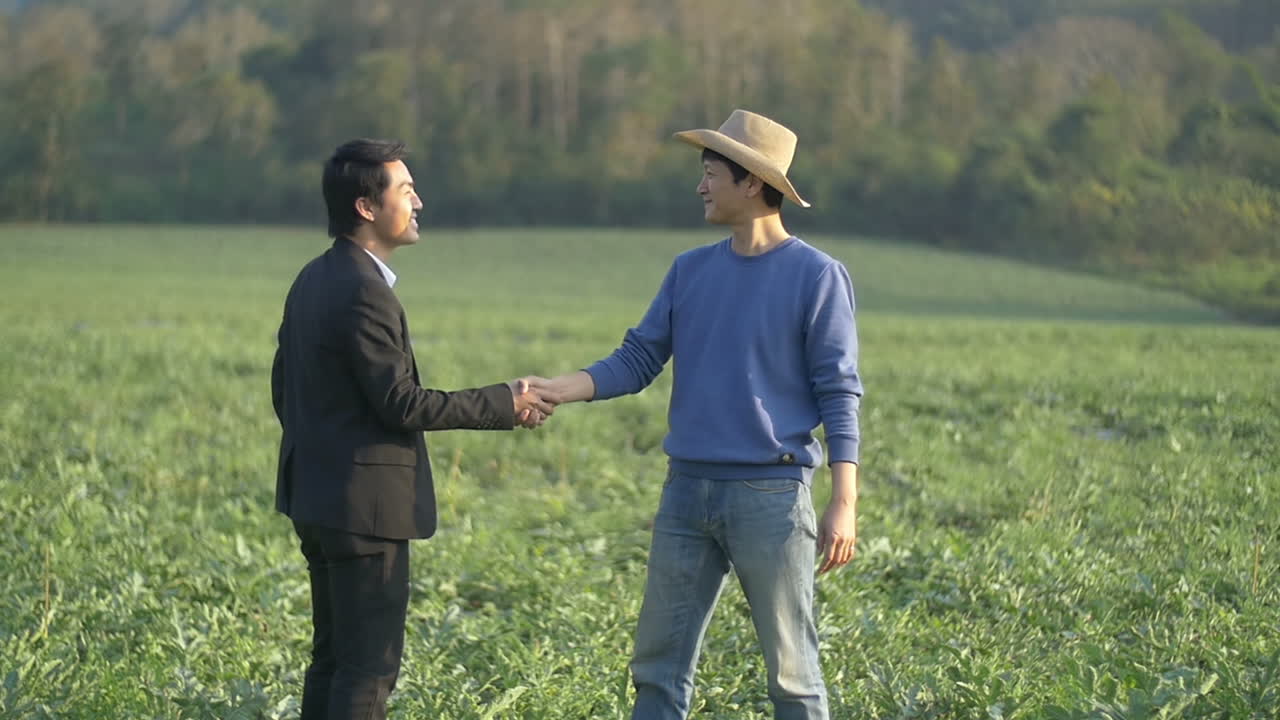 Farmer And Businessman Shaking Hands On Melon Field
