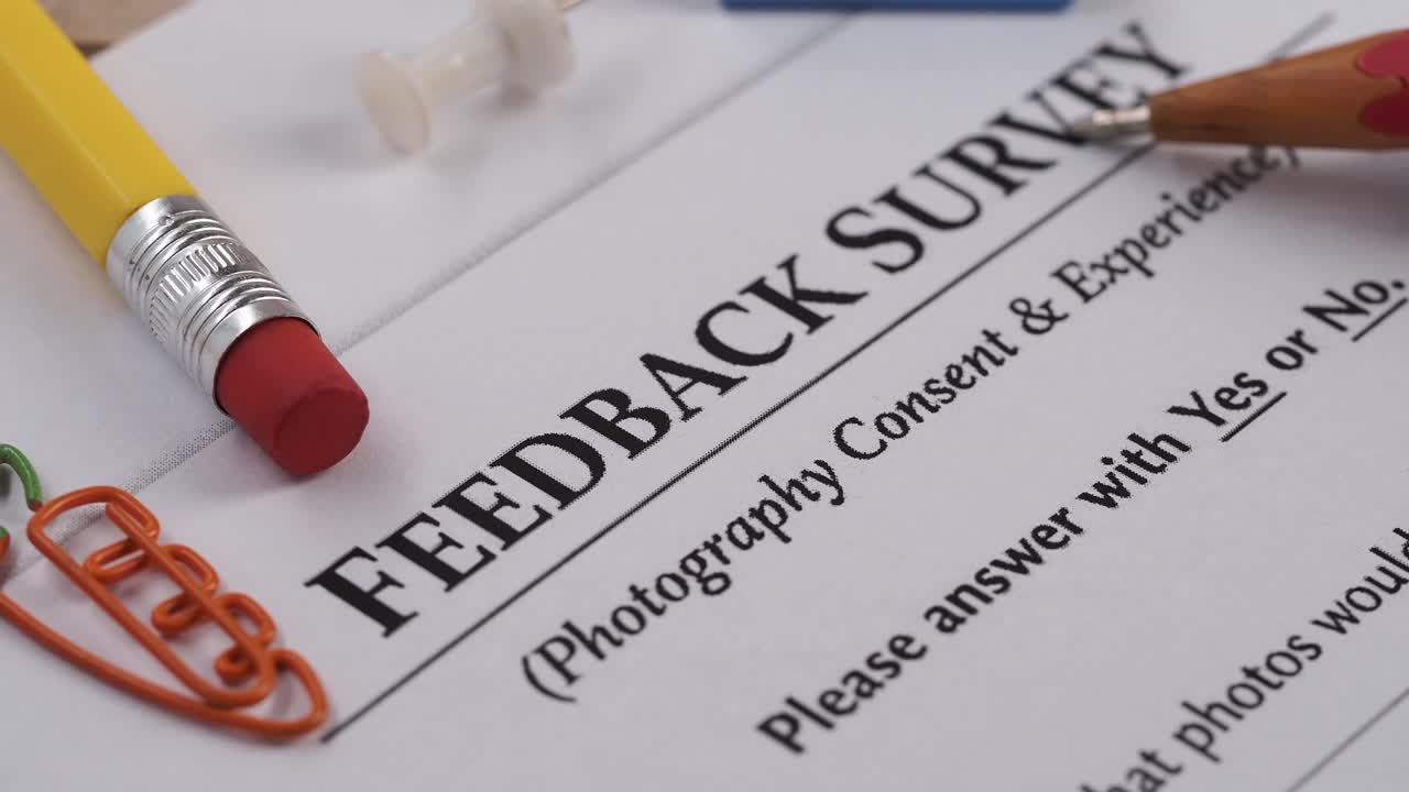 Red Pencil Pointing to Feedback Survey Form