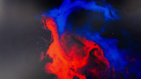 alcohol ink swirling in macro, abstract red and blue clouds on black background