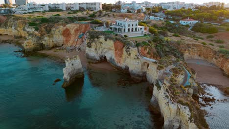 cliffs and historic buildings above portugal's turquoise waters
