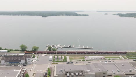 aerial shot of train rolling through downtown wayzata lake in minnetonka of usa at background