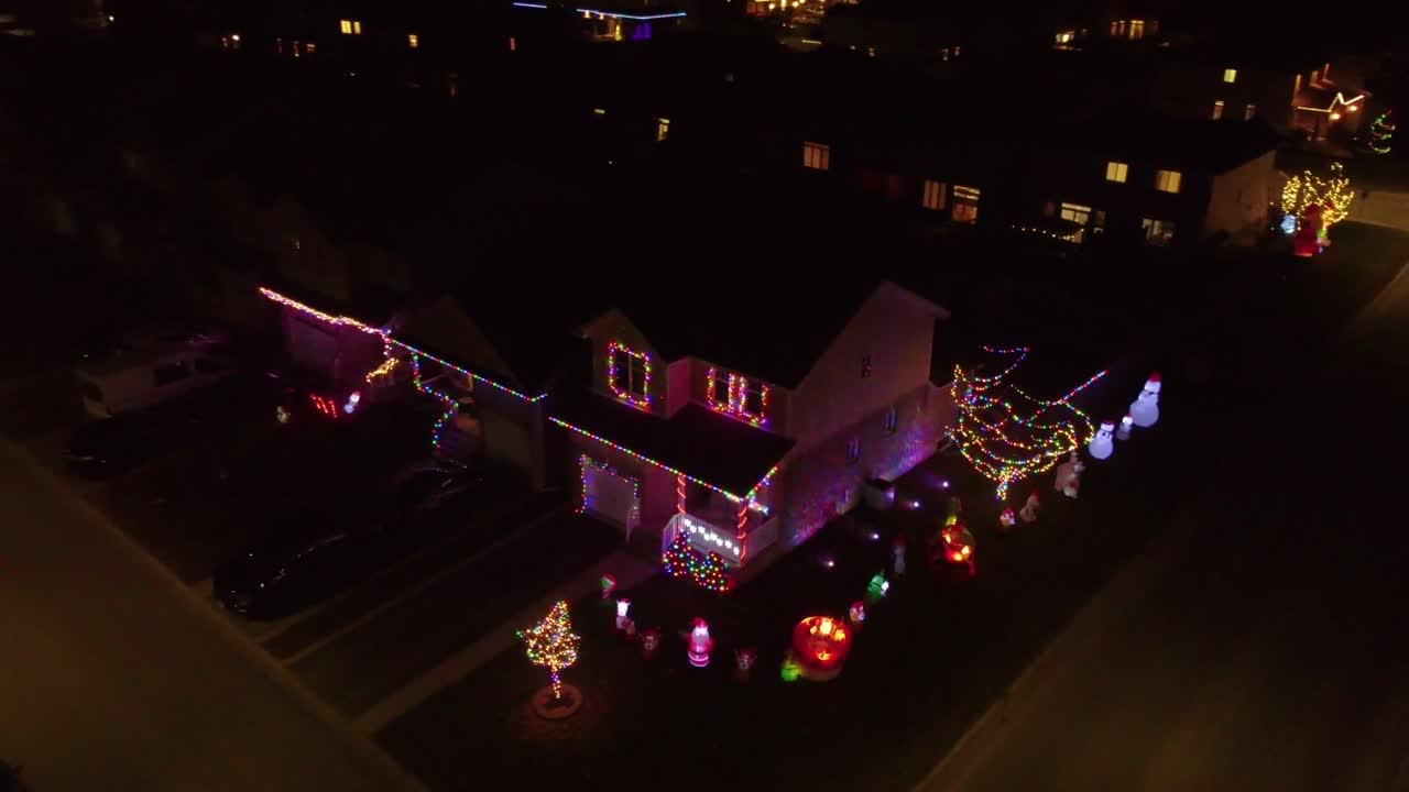 Christmas decorated homes in a city at night
