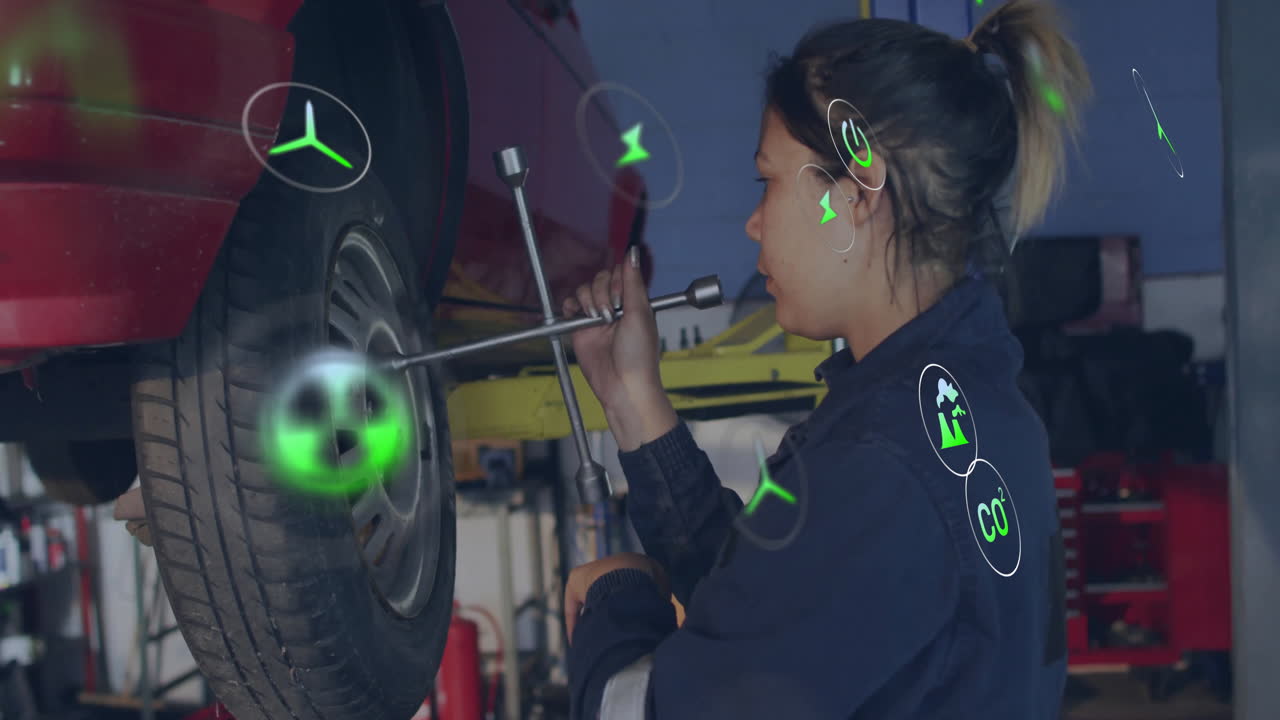 Mechanic using torque wrench on wheel in repair shop, showing floating green energy and CO2 icons
