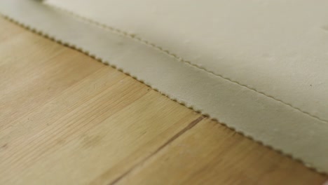 using fluted pastry wheel cutter to cut strips of dough