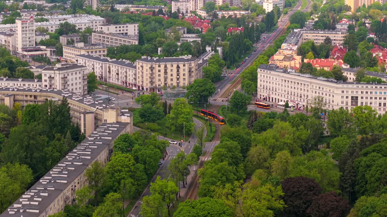 Drone establishing pullback over Zoliborz with Mickiewicza street and Wilson Square in spring