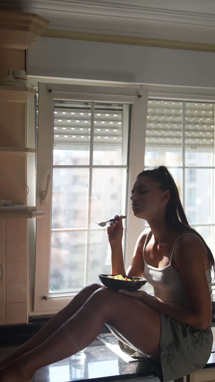 Woman Eating Salad by the Window