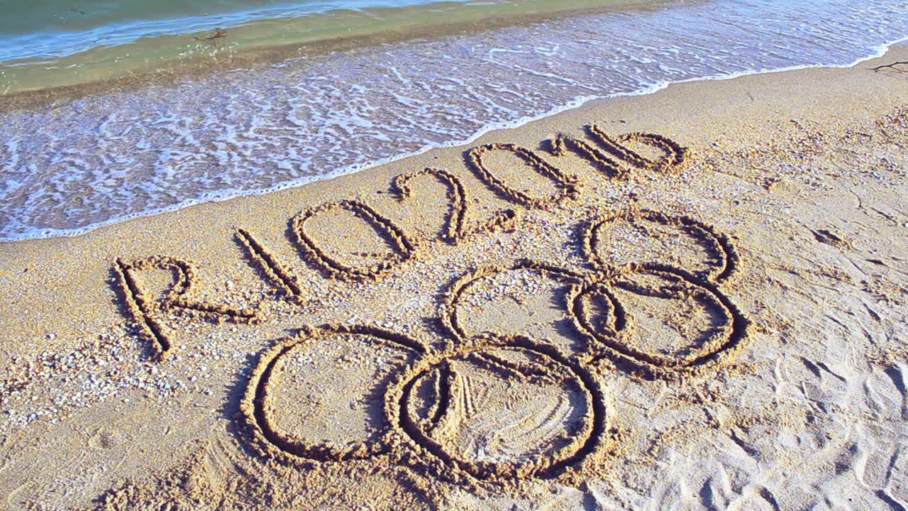 Rio 2016 an inscription on sand, the beach. Symbol Olympic game on sand, the beach