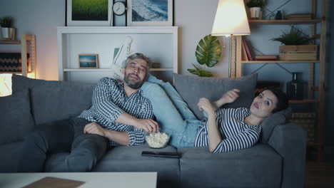 couple relaxing at home, watching movie