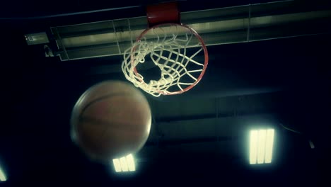 basketball hitting rim and falling into the net