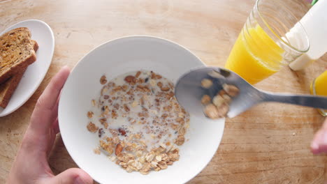 point of view of man eating cereal and drinking juice