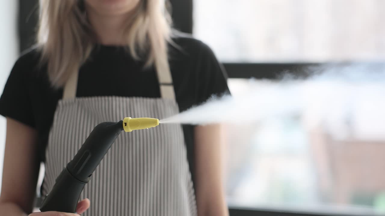 Woman using a steam cleaner