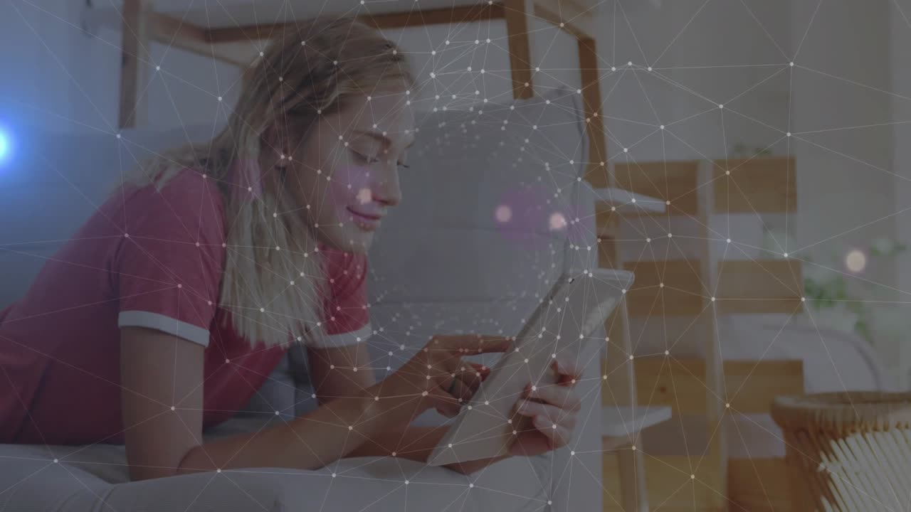 Woman reclining on couch tapping tablet for technology demo with animated network overlay shifting