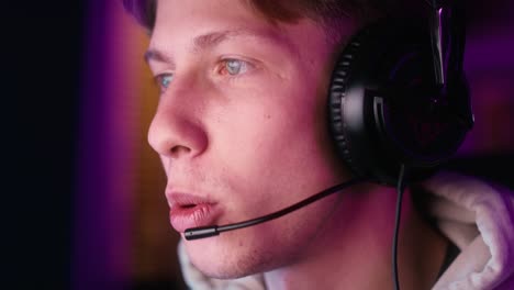 Caucasian-man-playing-game-at-night-among-neon-lightning