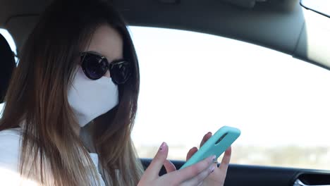 sick girl wearing protection during pandemic. pretty young caucasian girl taking on medical mask outdoor. girl wearing medical mask during coronavirus covid-19 epidemic