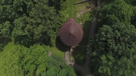 the roof of a historic medieval tower in the middle of a park in a city in central europe, captured from a bird's-eye view in 4k resolution