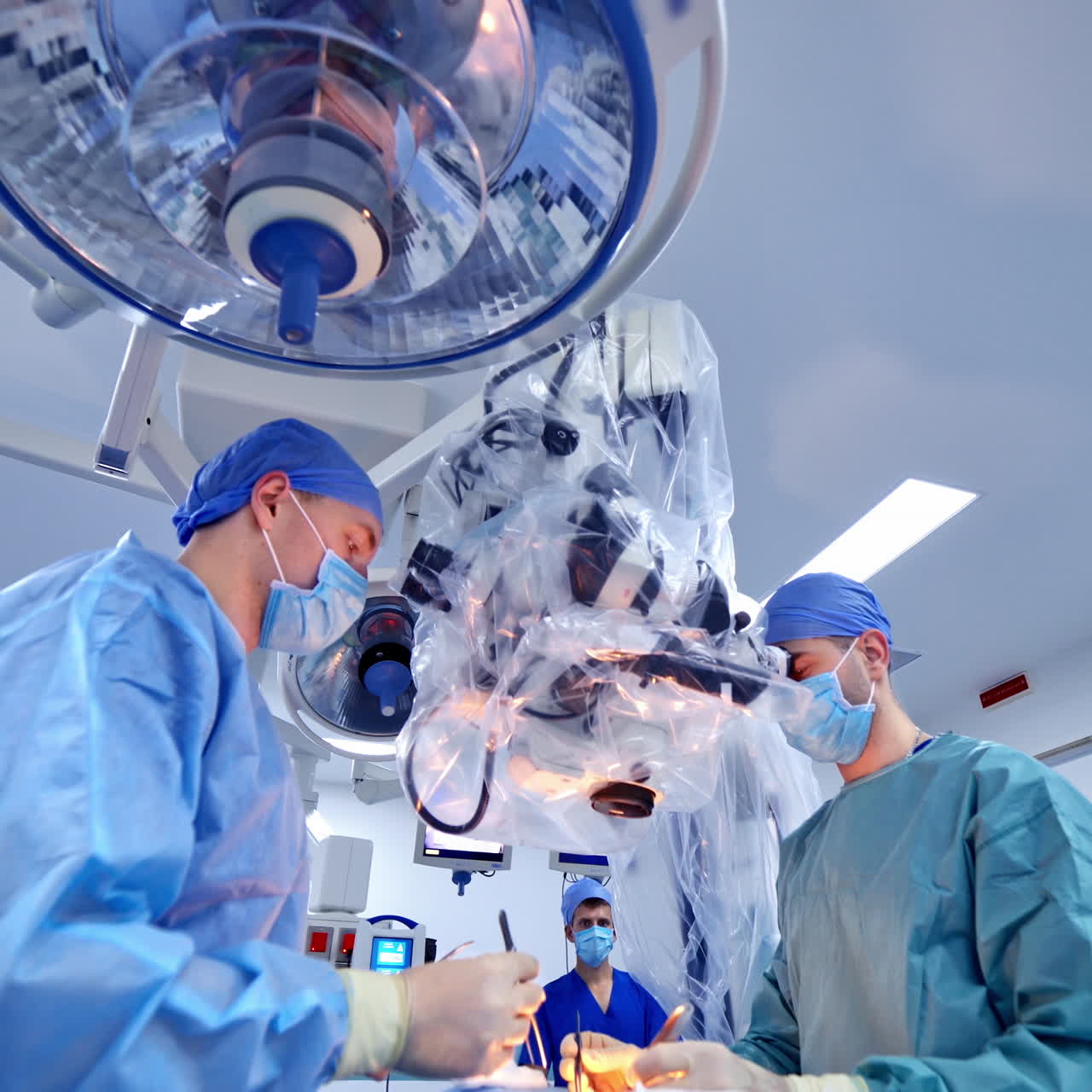 Operation through the modern equipment in hospital. Surgeons perform surgery in the neurosurgical department using modern technology.