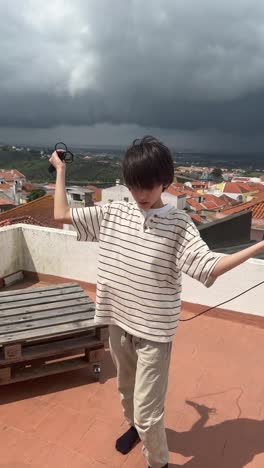 boy jumping rope on a rooftop