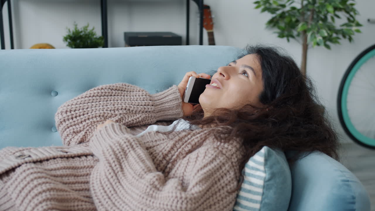 Woman having a phone conversation at home