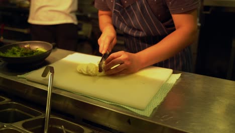 slicing cheese in italian restaurant kitchen