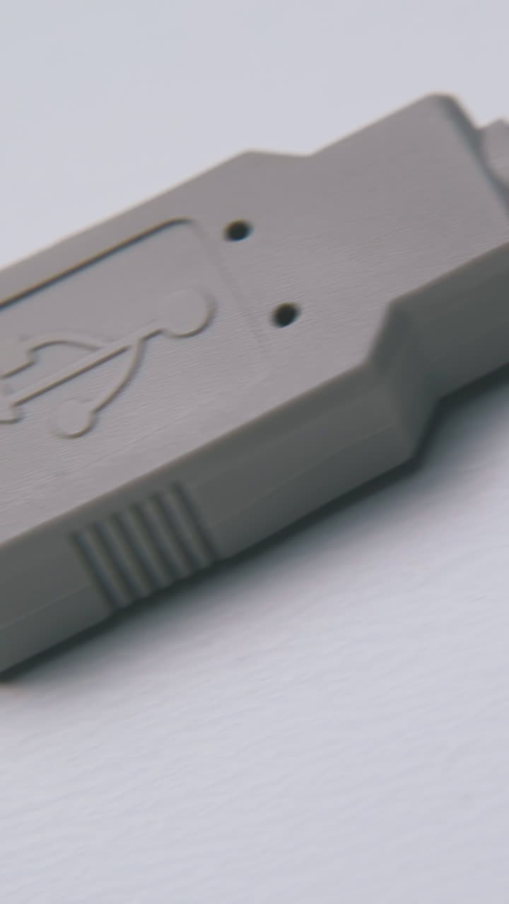 motion past grey usb cable with different plugs for connection on empty white background macro