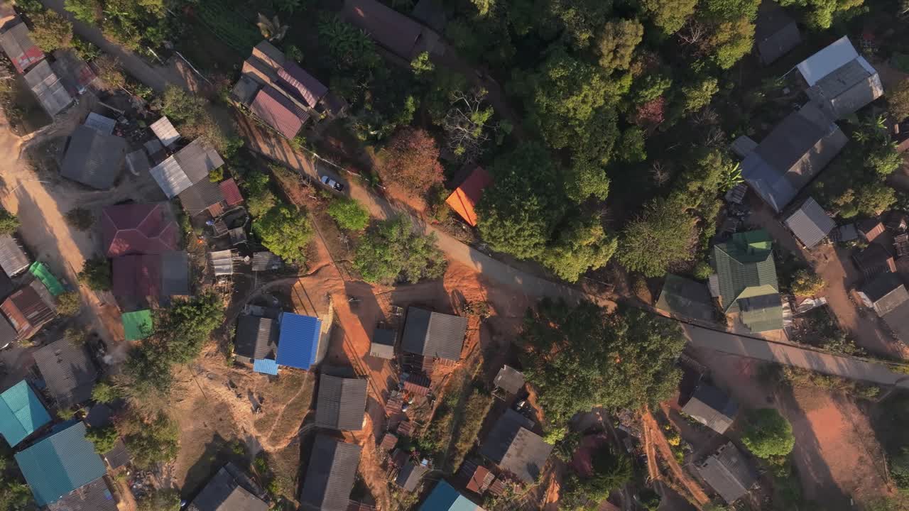 Small hillside dwellings hidden in lush wilderness, Thailand