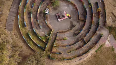 top down aerial view of labyrinth made from colored logs