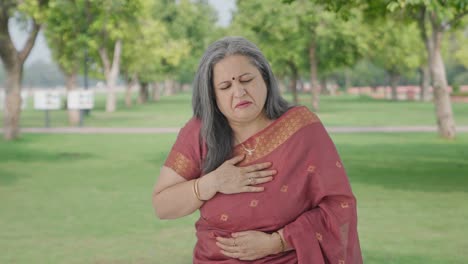 Sick-Indian-old-woman-suffering-from-cold-and-cough-in-park