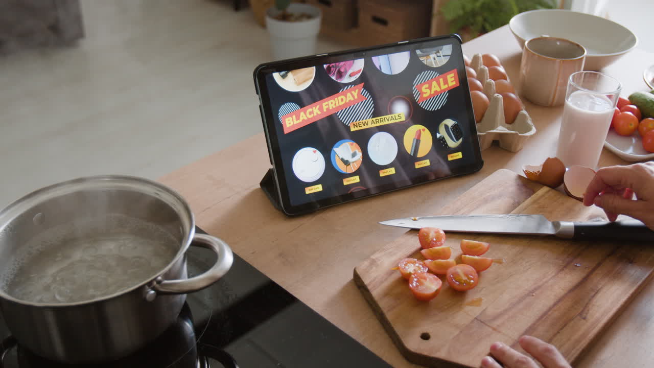 Cooking in the Kitchen with Tablet Displaying Black Friday Sale