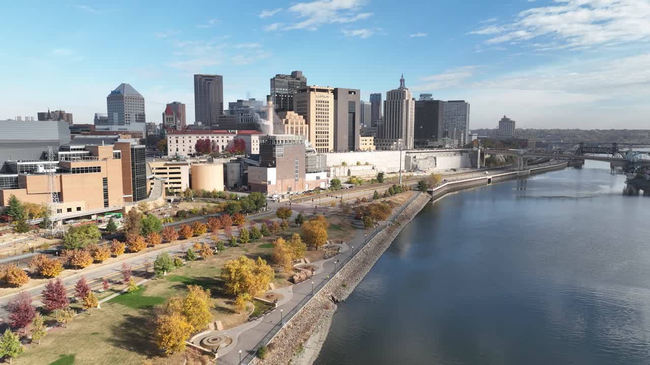 Aerial view of St. Paul Minnesota's downtown skyline along the Mississippi River with vibrant fall colors