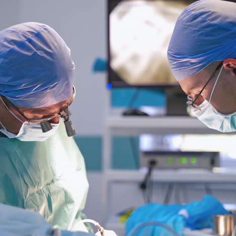 professional doctors perform a surgery. group of surgeons in medical uniform in the operating room in the hospital. side view of specialists in clinic.