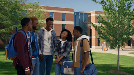 happy group of diverse students socializing and laughing on university campus
