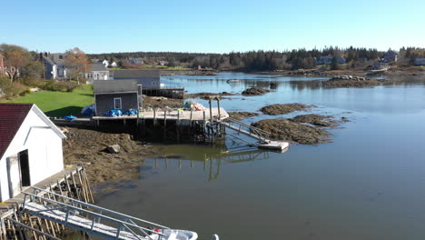 aerial fly over drone footage over coastal houses on maine coast of vinalhaven, fox islands, knox county maine, usa