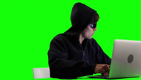 hacker using laptop with green screen