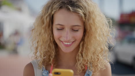 portrait of beautiful blonde woman using smartphone enjoying texting browsing on summer vacation sharing experience online attractive female tourist beachfront